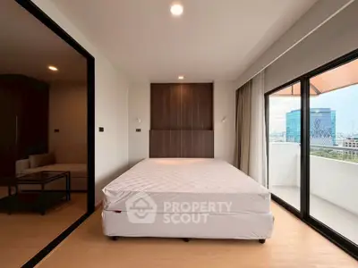 Modern bedroom with large windows and balcony offering city views, featuring a minimalist design and natural light.