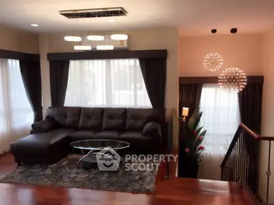 Luxurious living room with modern chandelier and plush leather sofa