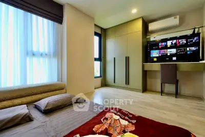 Modern bedroom with built-in wardrobe and entertainment setup