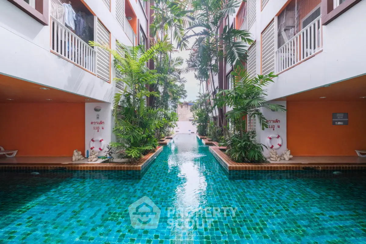 Luxurious apartment complex with stunning pool and lush greenery, perfect for relaxation and leisure.