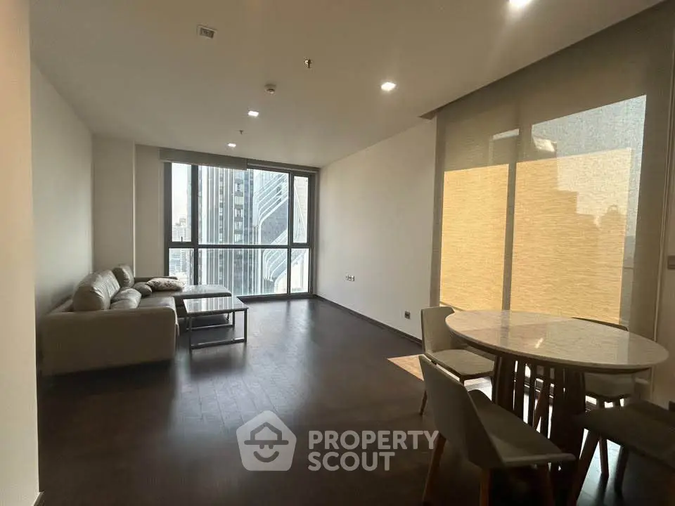Spacious modern living room with city view and elegant dining area