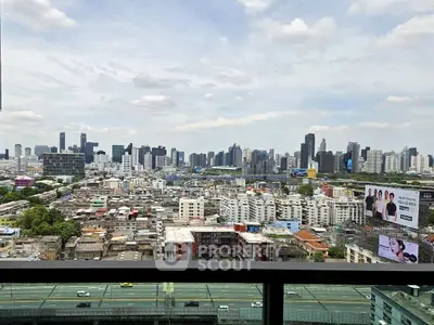 Stunning cityscape view from high-rise balcony overlooking urban skyline.