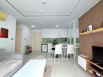Modern open-plan living room with sleek kitchen and stylish decor