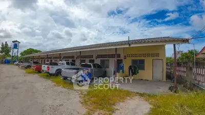 Spacious row of residential units with ample parking and open surroundings.