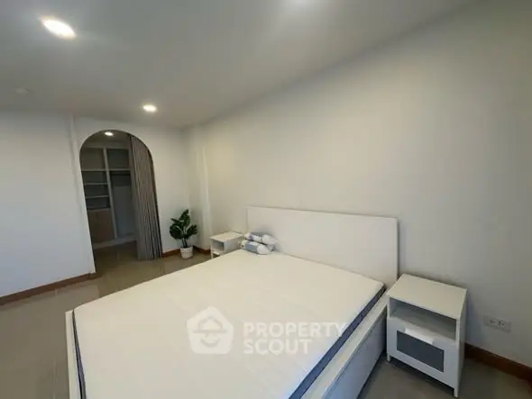 Spacious bedroom with modern design and ample storage space