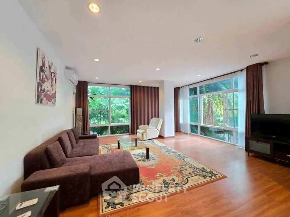 Spacious living room with large windows and elegant decor