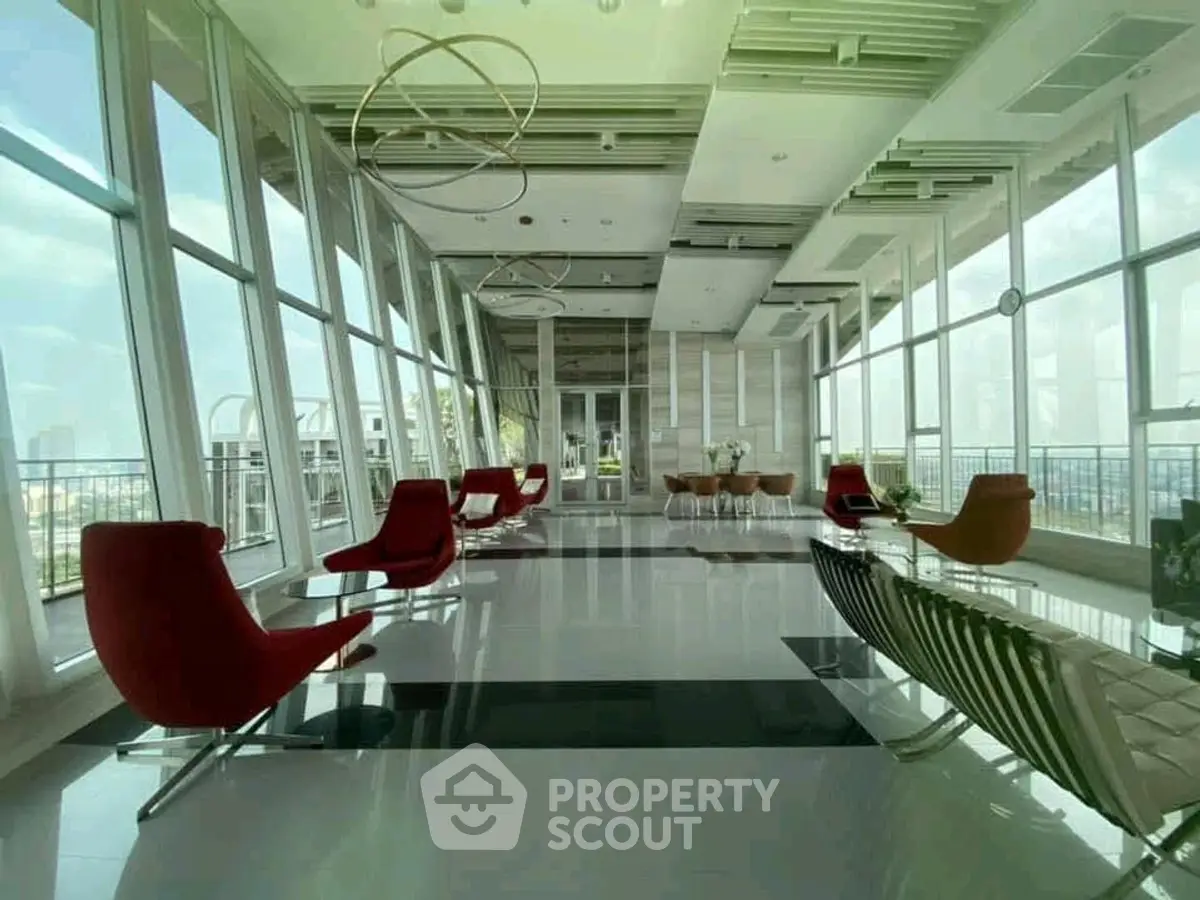 Luxurious modern building interior with panoramic city views and stylish seating area.