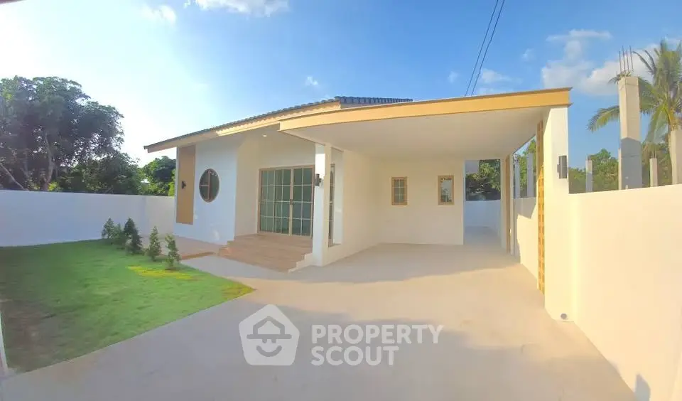 Charming modern house with spacious driveway and lush garden, perfect for serene living.