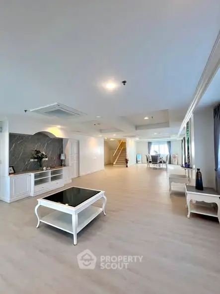 Spacious modern living room with elegant decor and open layout, perfect for entertaining.