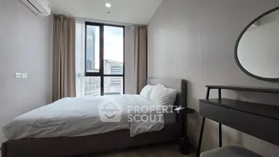 Modern bedroom with large window and stylish decor in urban apartment