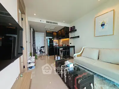 Modern living room with stylish decor and open kitchen layout in a luxurious apartment.