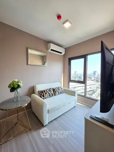 Modern living room with city view, featuring a cozy sofa and stylish decor.