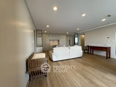 Spacious modern living room with elegant wooden flooring and cozy seating area