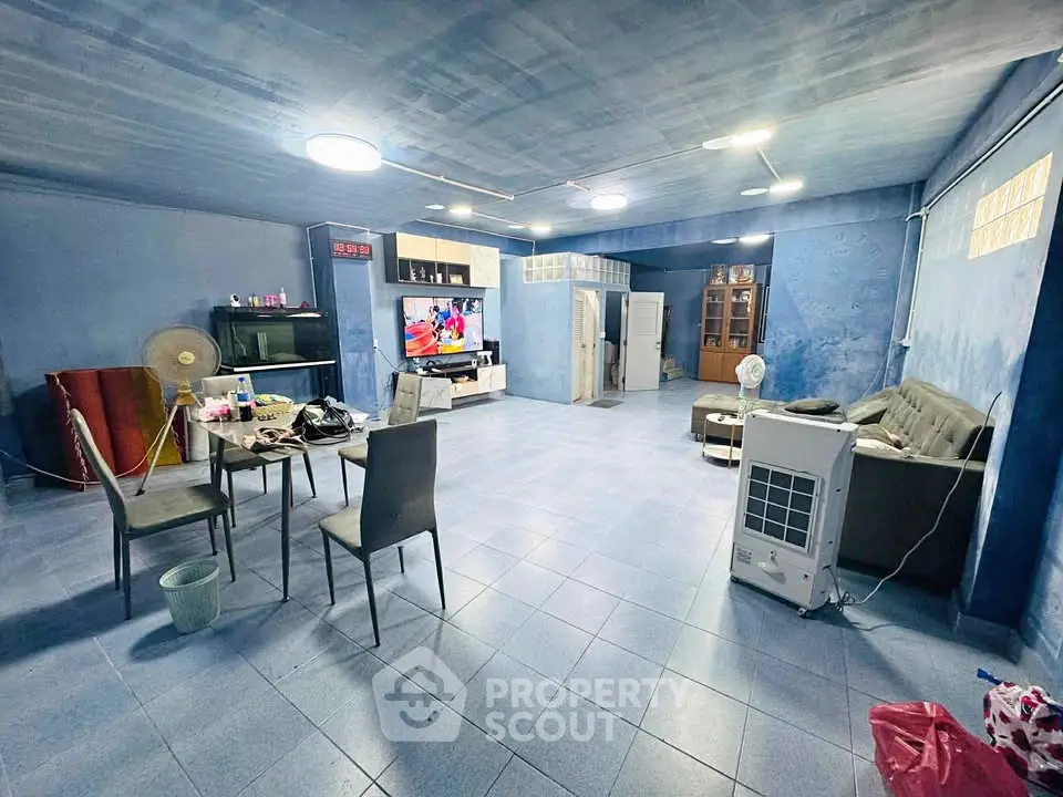 Spacious living room with modern decor and entertainment center, perfect for family gatherings.