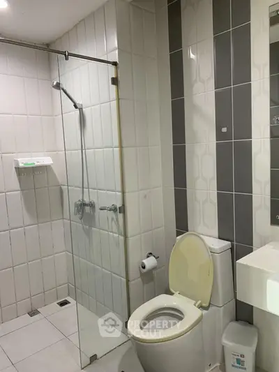 Modern bathroom with glass shower and sleek tile design