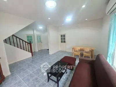 Spacious living room with modern furniture and natural light, perfect for family gatherings.