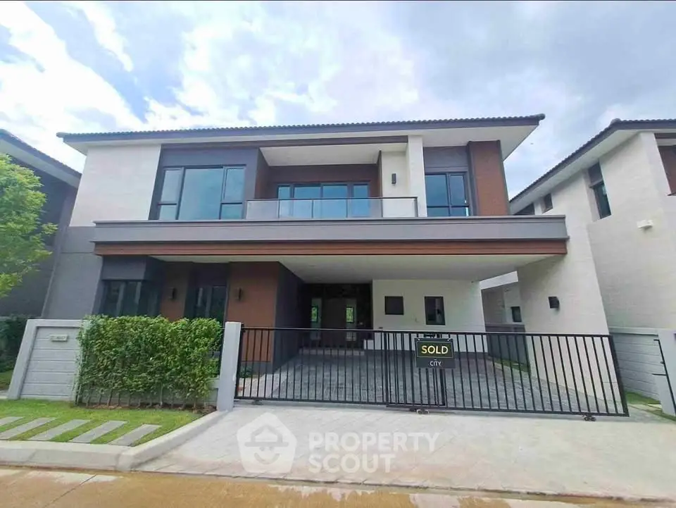Modern two-story house with sleek design and spacious driveway in a serene neighborhood.