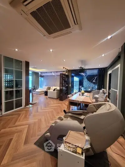 Spacious modern living room with elegant wood flooring and stylish furniture