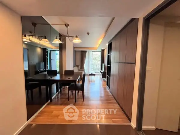 Spacious modern living room with elegant dining area and large windows.