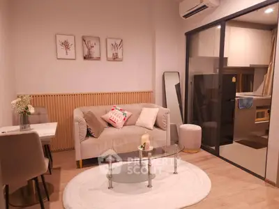 Charming living room with modern decor and cozy ambiance, featuring a glass coffee table and stylish wall art.