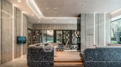 Luxurious modern living room with elegant decor and large windows offering natural light.