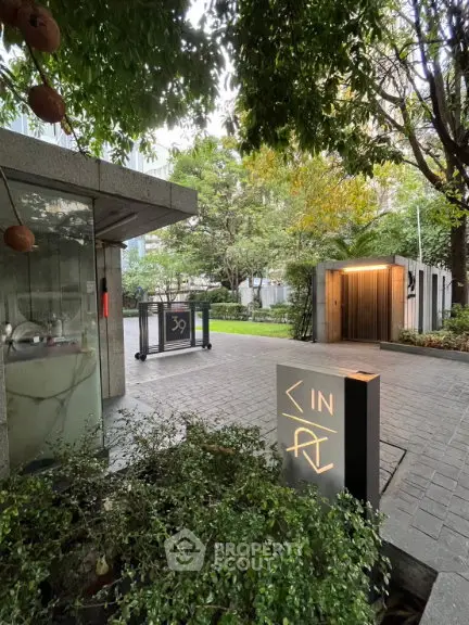 Luxurious garden entrance with modern design and lush greenery in a prestigious property.