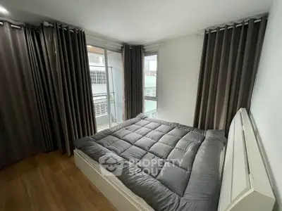 Cozy bedroom with large windows and modern decor in urban apartment