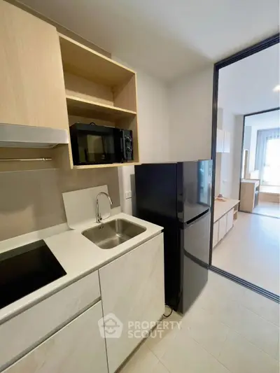 Modern kitchen with sleek appliances and open layout in stylish apartment