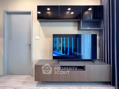 Modern living room with sleek TV stand and wall-mounted cabinets