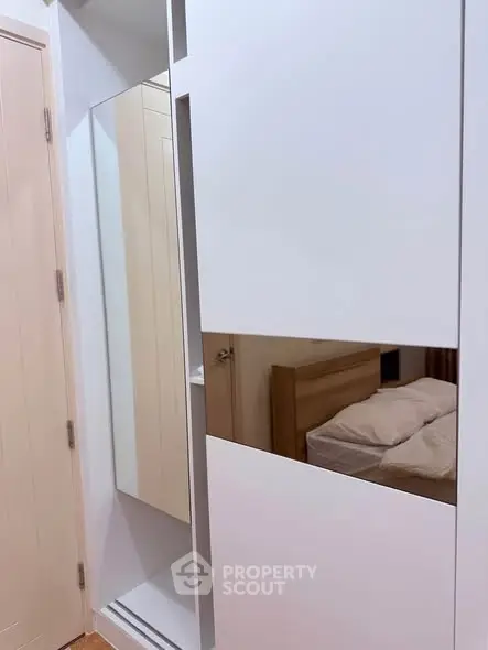 Modern bedroom with sleek white wardrobe and cozy bed