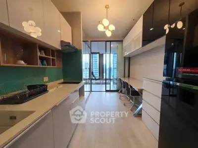 Modern kitchen with sleek cabinetry and open layout, featuring a bright dining area with city view.