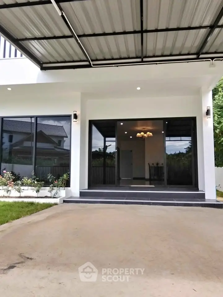 Modern house exterior with covered carport and large glass windows