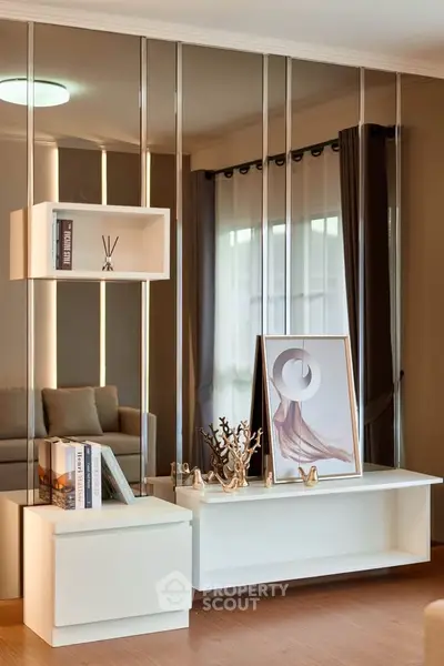 Stylish modern living room with elegant decor and mirrored wall panels