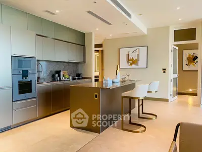 Luxurious modern kitchen with sleek design and high-end appliances, featuring an open layout and stylish bar seating.