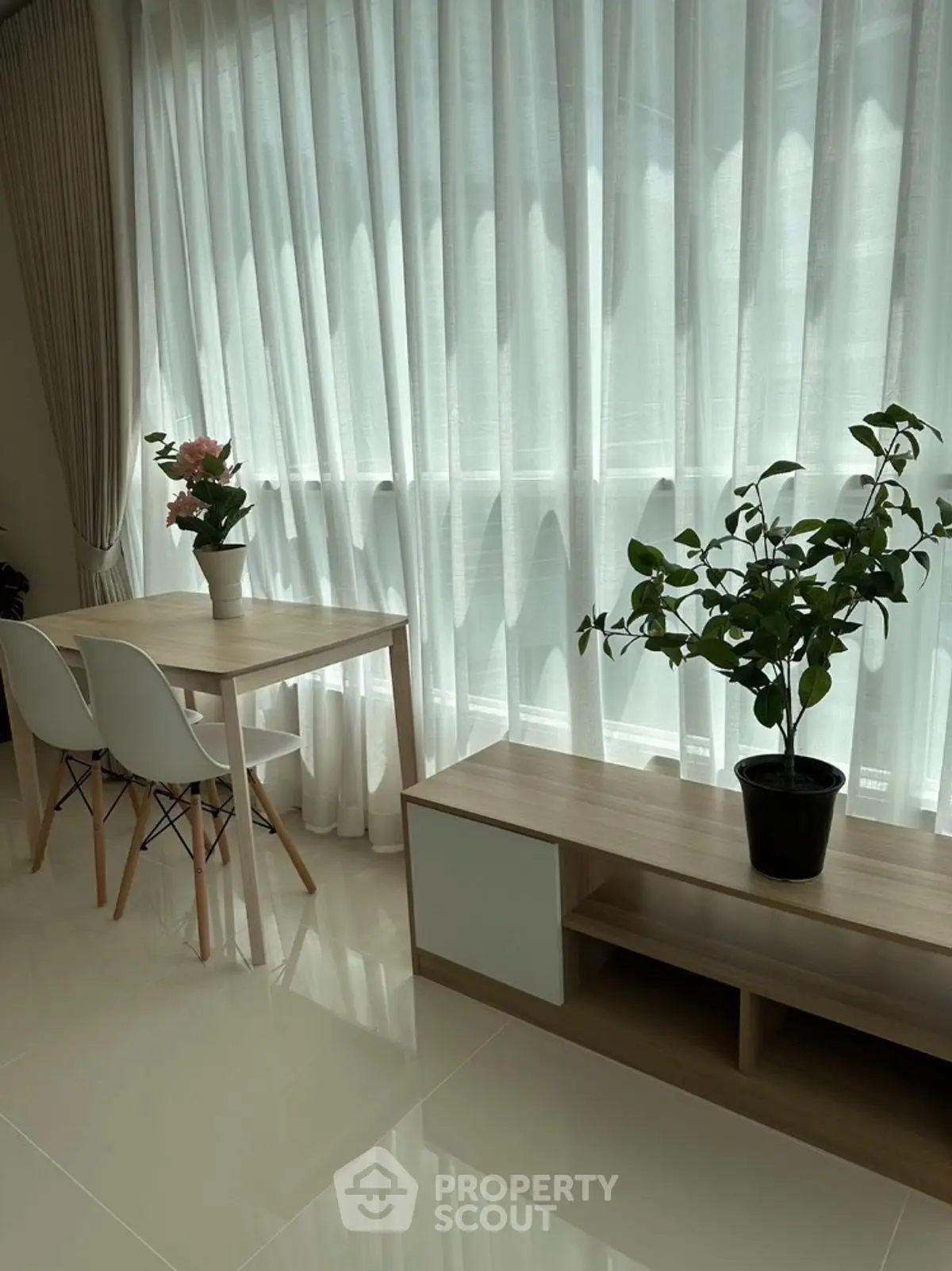 Bright modern living room with large windows and elegant decor