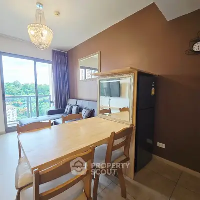 Modern living room with dining area and balcony view in a stylish apartment.