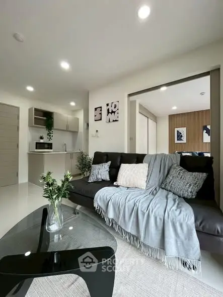 Modern living room with cozy sofa and open kitchen layout