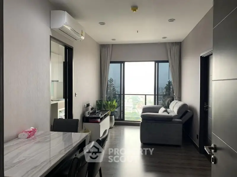 Modern living room with large window and stylish furniture