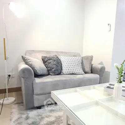 Cozy living room with plush gray sofa and modern decor