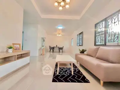 Spacious modern living room with elegant decor and ample natural light.