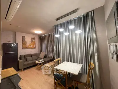 Modern living room with stylish decor and dining area in a cozy apartment.