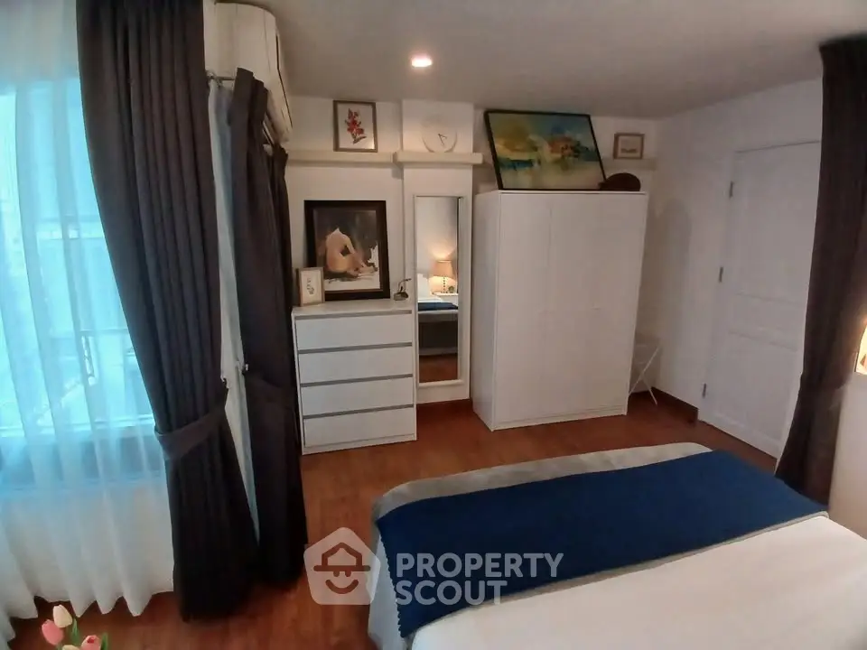 Cozy bedroom with elegant decor and ample natural light