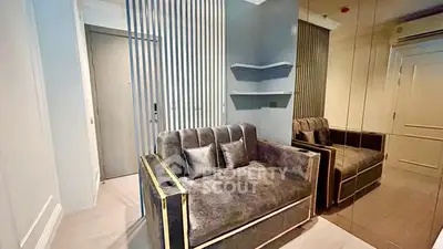 Modern living room with plush sofa and mirrored wall in stylish apartment.