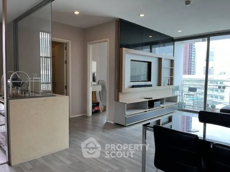 Modern living room with sleek design and city view, featuring open layout and stylish furnishings.