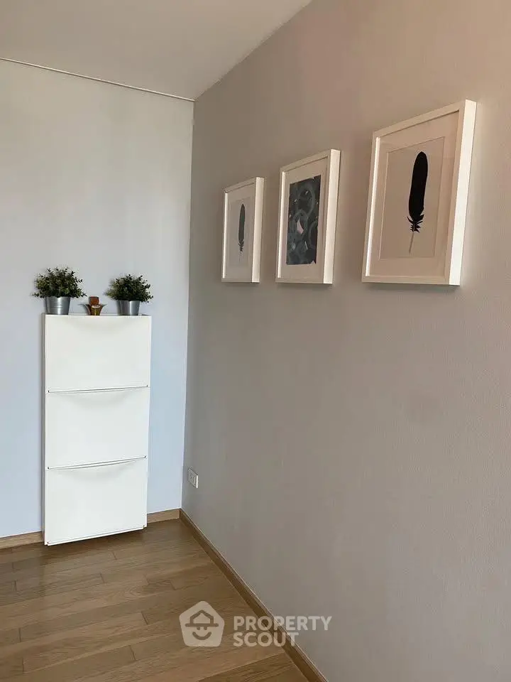 Minimalist hallway with wooden flooring and framed art on the wall