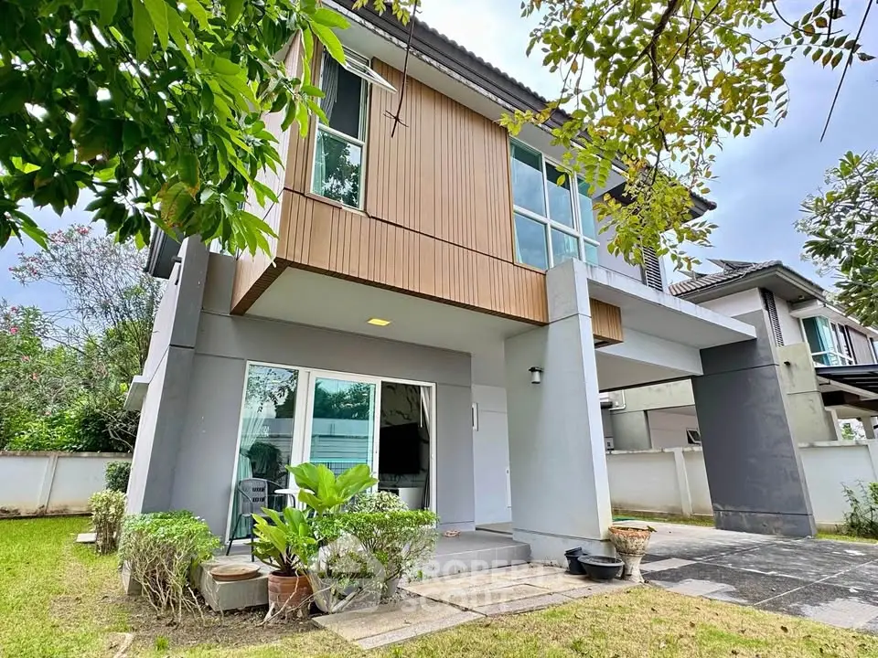 Modern two-story house with lush garden and contemporary design