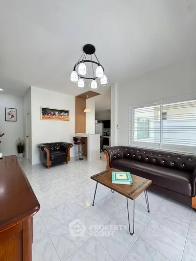 Spacious living room with modern leather sofas and stylish lighting