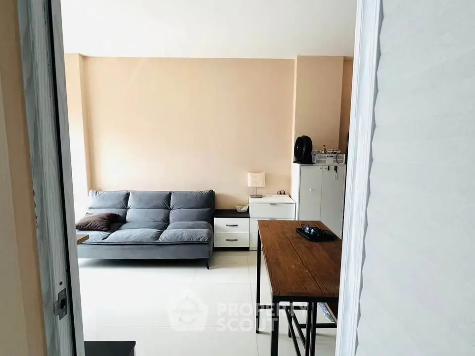 Modern living room with sleek furniture and natural light, perfect for urban living.