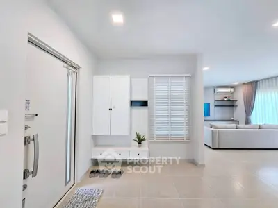 Modern minimalist living room with sleek white decor and open layout