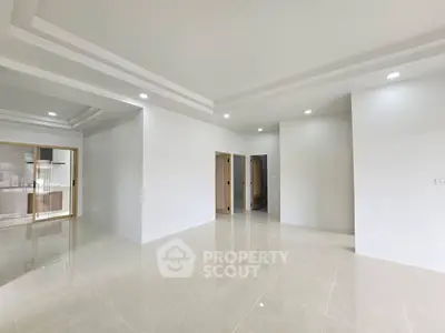 Spacious modern living room with elegant ceiling design and glossy tiled flooring